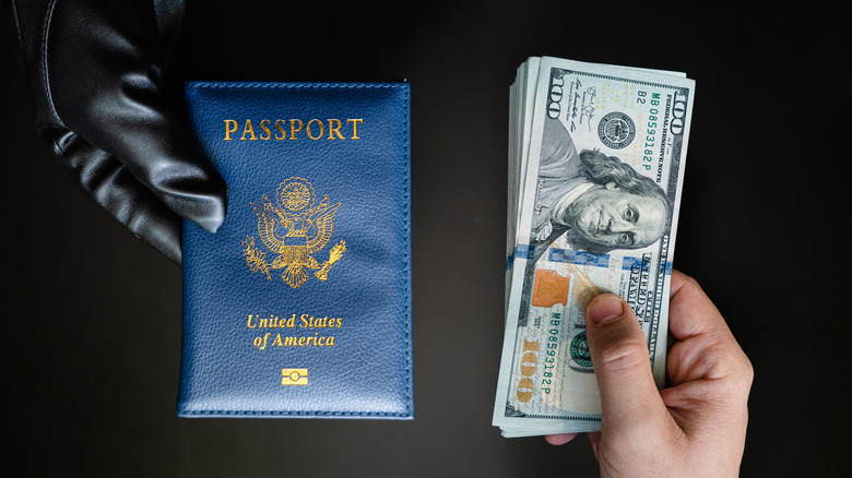 A gloved hand holding a passport