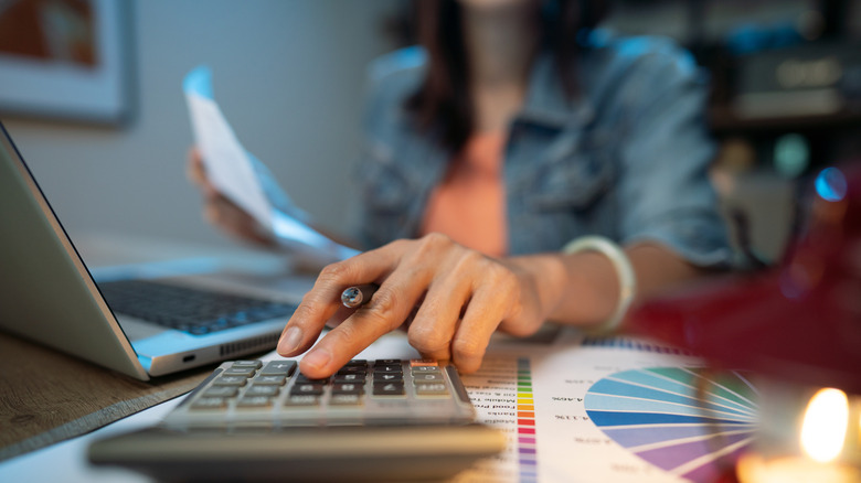 a woman calculating her finances