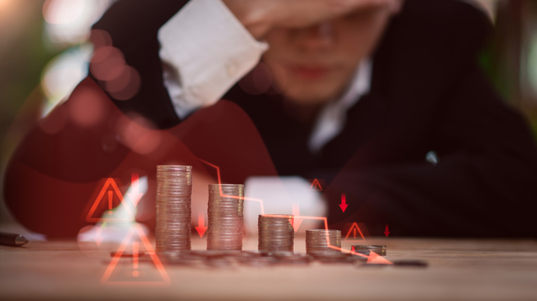 image of coins and red finance arrows