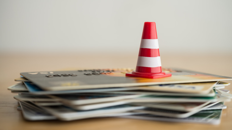 hazard cone on stack of credit cards