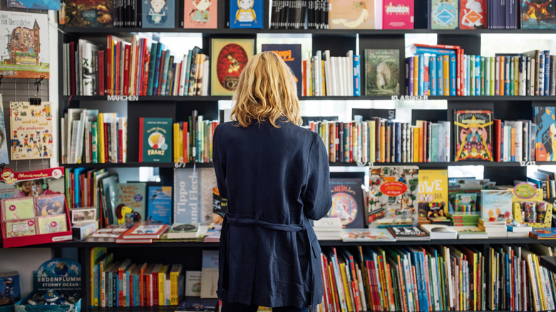 A woman shopping for books at a book store