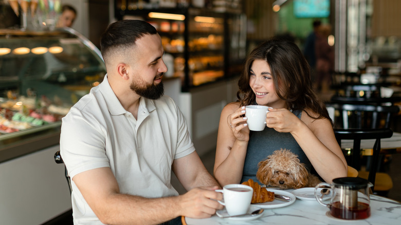 A happy couple having coffee together in a cafe