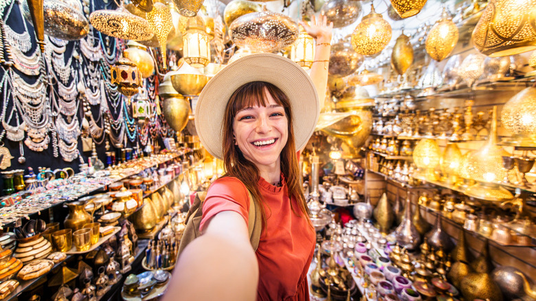 A smiling woman in an antique shop