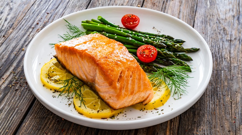 classic white plate with salmon being served on it