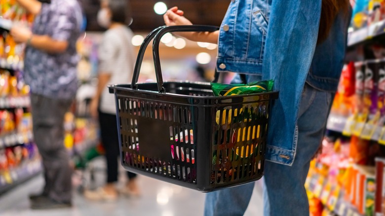 shopper holding grocery basket