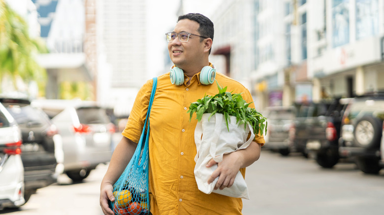 man carrying bags of groceries