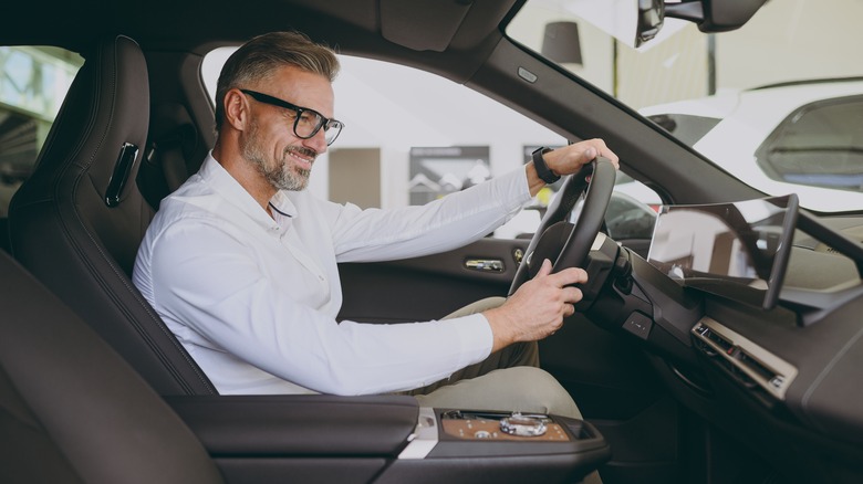 A smiling man in a vehicle