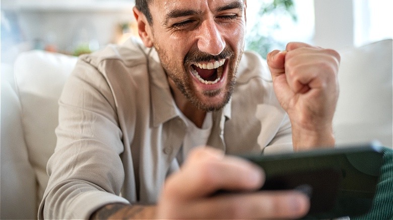 Person celebrating news on phone