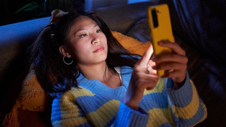 Person laying down with phone