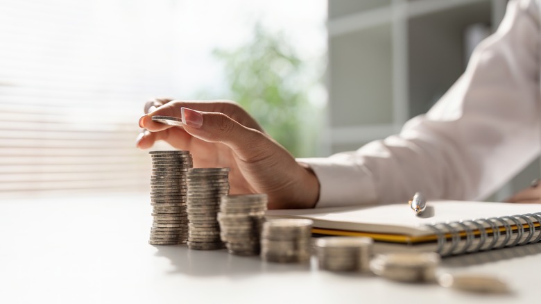 woman counting stacks of coins