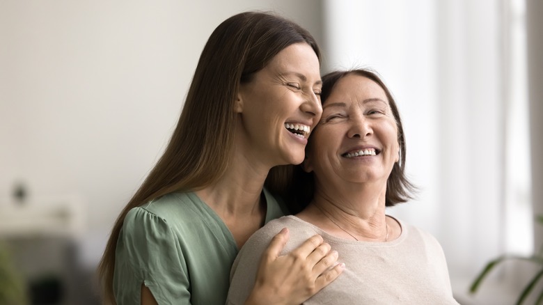 younger woman caring for her mom