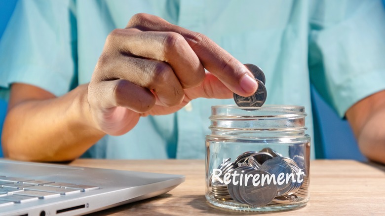 putting coins in retirement jar