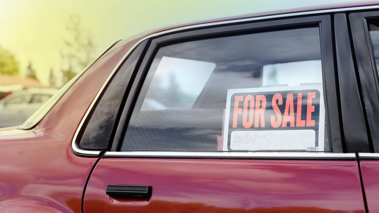 Vehicle with for sale sign in window