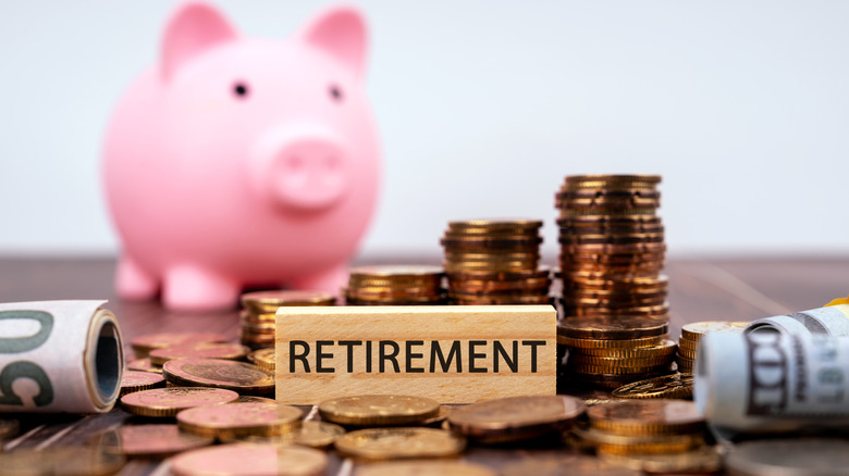 piggy bank, money, and block reading retirement