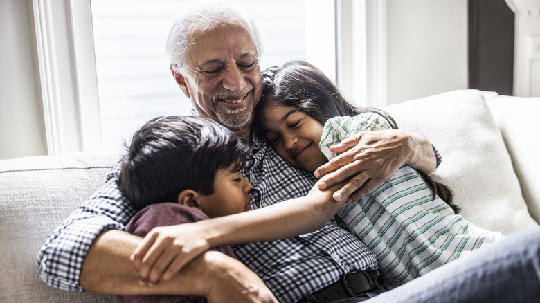 an older man with two young children