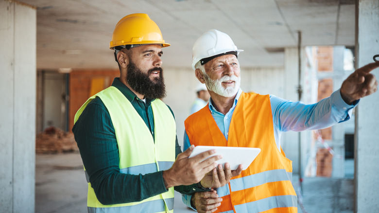 an older worker talking with coworker