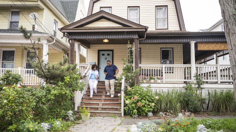 people walking down steps of front porch