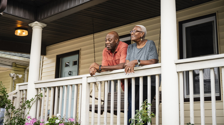 retirees standing on a porch