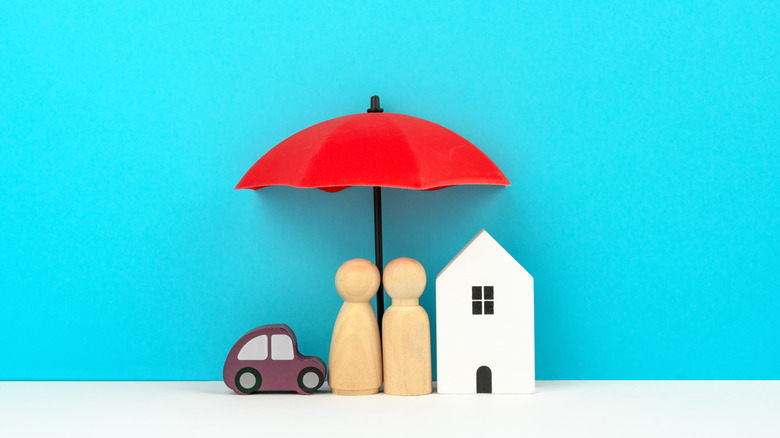 two people figures under umbrella