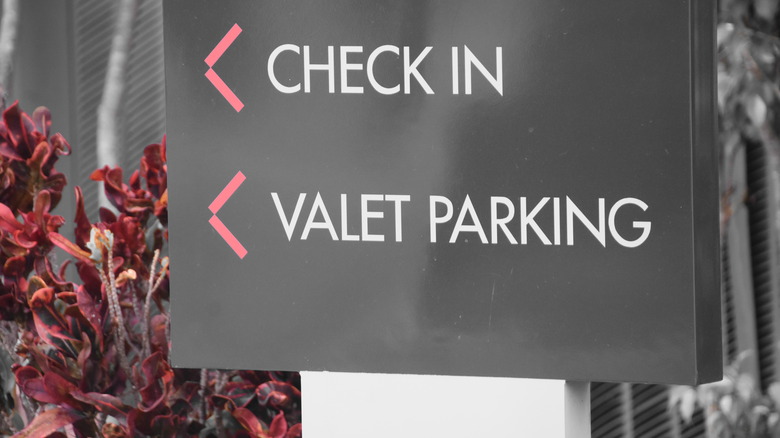 hotel sign showing check-in and valet parking