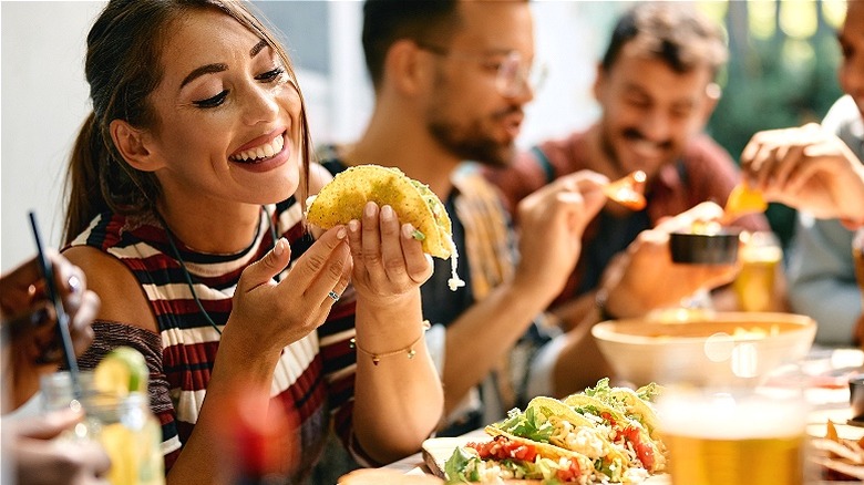 Person smiling, looking at taco