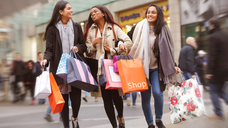 Three women walking with shopping bags