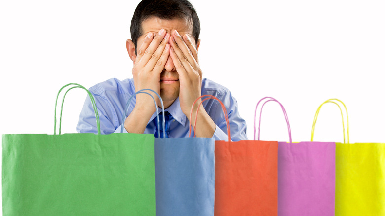 person refusing to look at shopping bags