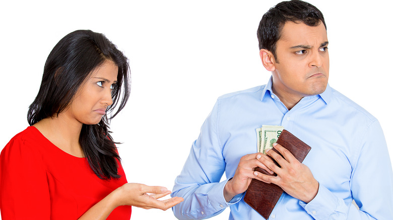 unhappy woman asking man for some money