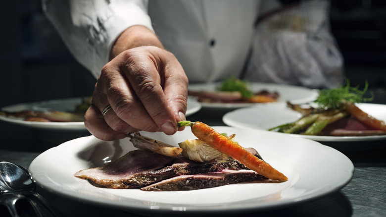 A hand plating food