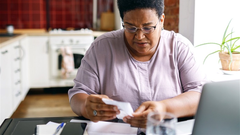 Person looking over receipt