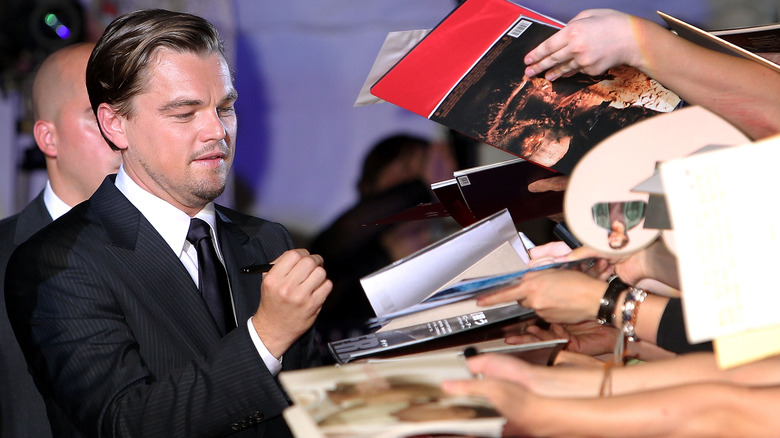 Leonardo DiCaprio signing autographs