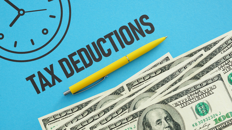 Tax deductions written next to money