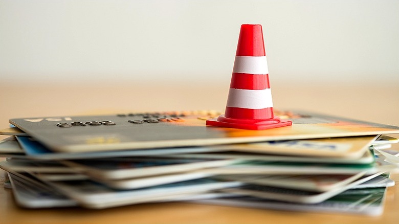 Hazard cone on stack of credit cards