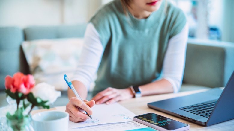 young woman calculating on computer