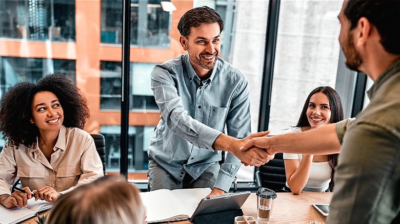 Handshake during group business meeting