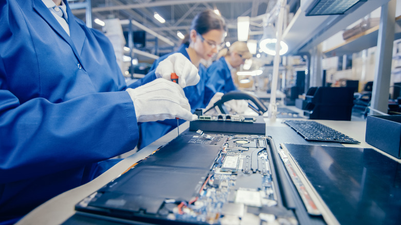 workers making laptops in factory