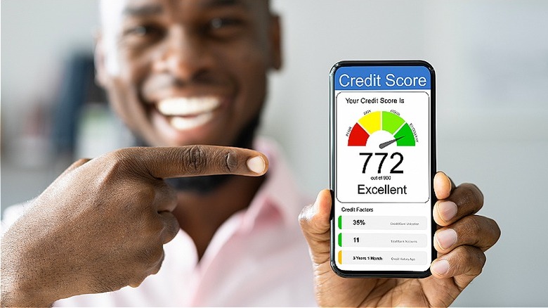 Person pointing, 772 credit score