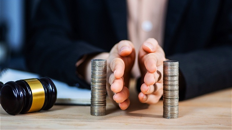 Person separating money stacks