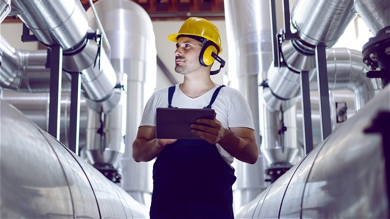 Power plant operator inspecting equipment