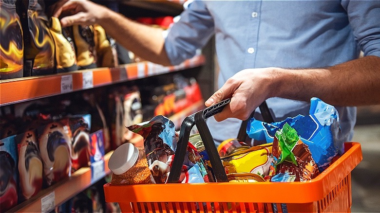 Person shopping groceries with basket