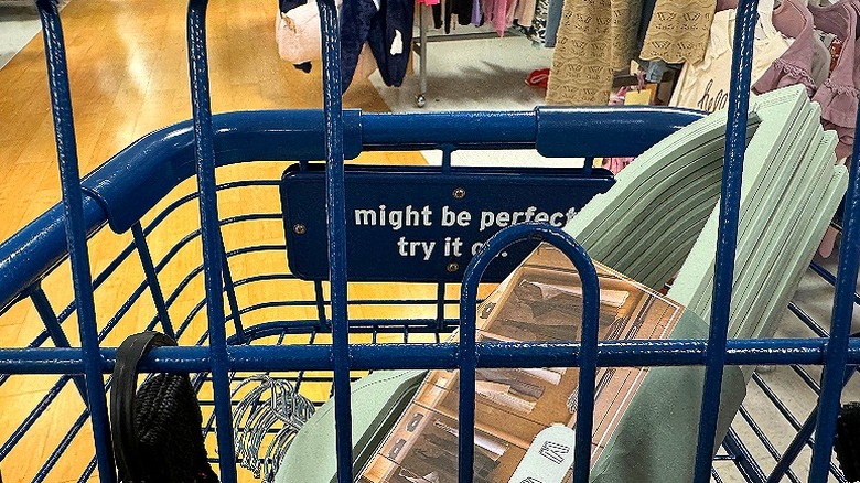 Shopping cart with items in basket, moving through store floor