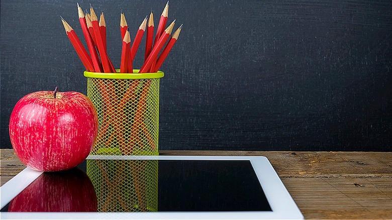 tablet with apple and pencils