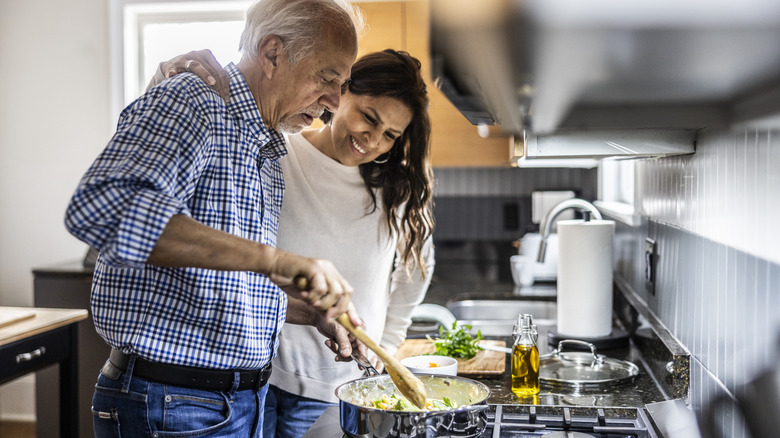 Mature couple cooking together.