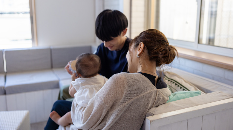 Couple with infant on couch