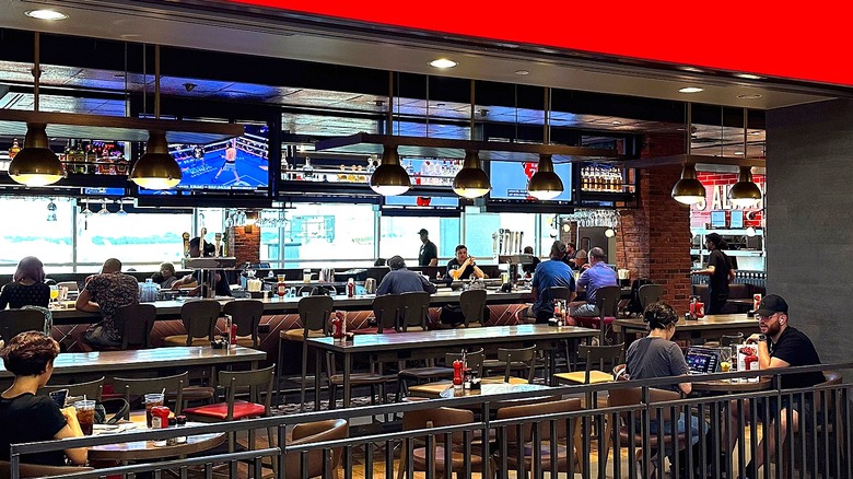 Inside look at a TGI Fridays with customers dining and watching sports