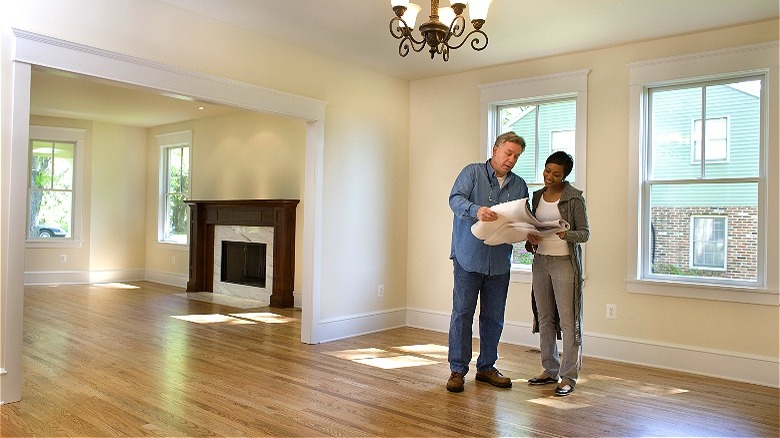 Contractor reviewing blueprints with homeowner