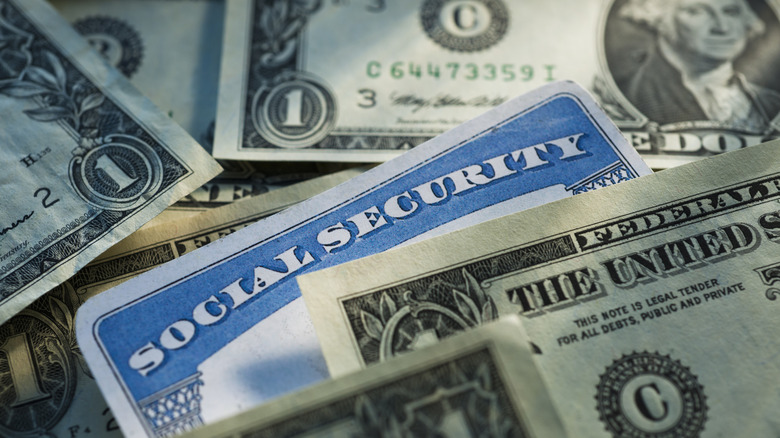 a social security card mixed in with dollar bills