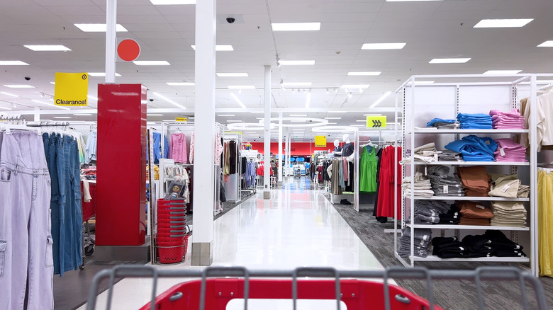 POV: shopper pushing a shopping cart through a brightly lit Target store.