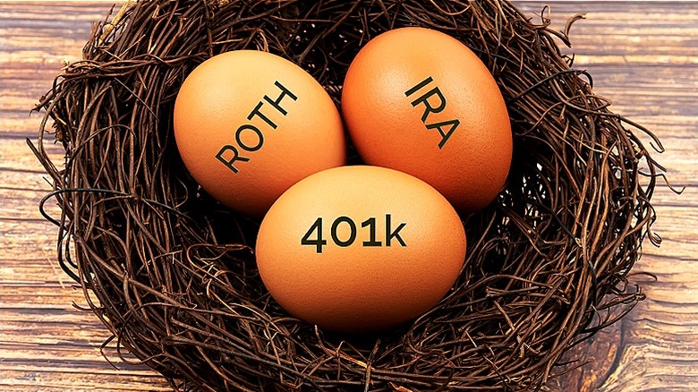 Eggs reading 'Roth,' 'IRA,' and '401k' in a nest on wooden table