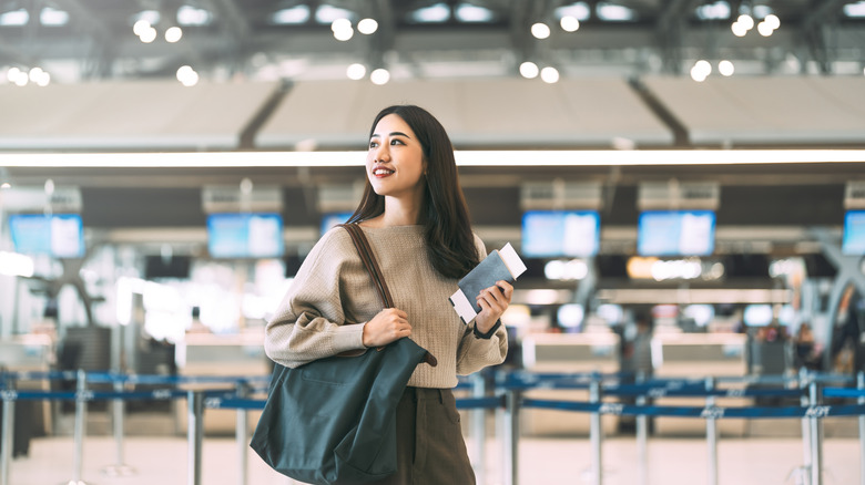 Passenger at international airport terminal for departure with airline transport.